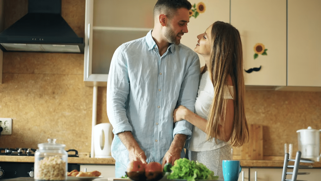 A man cooking with a woman because she likes it.