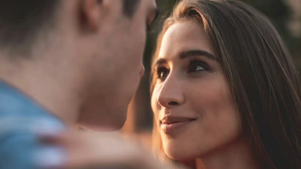 A woman staring into a man’s eyes while smiling.