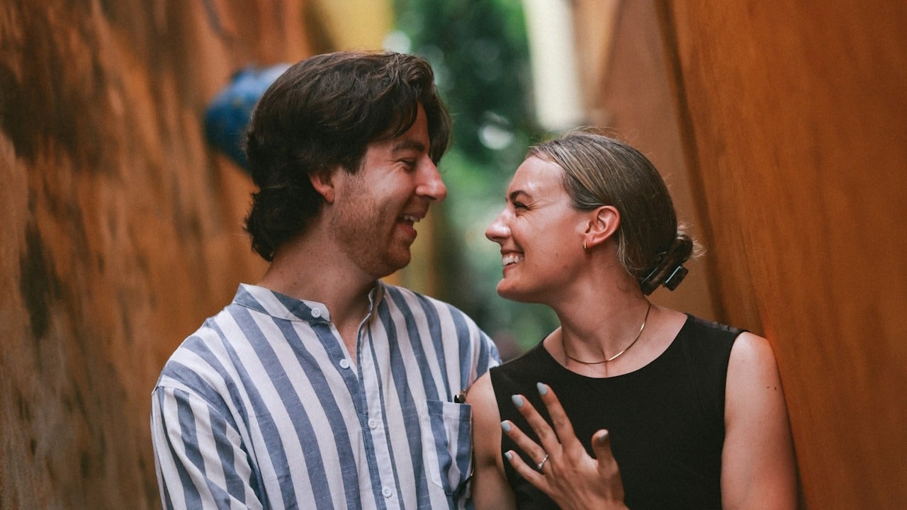 A couple smiling at each other.