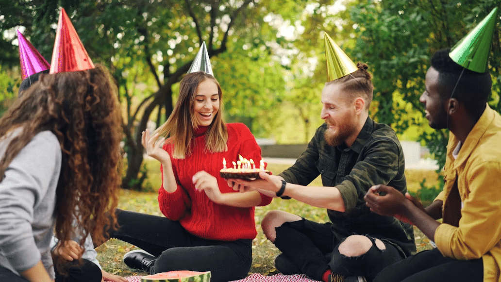 A man celebrating a surprise birthday party for his girlfriend.