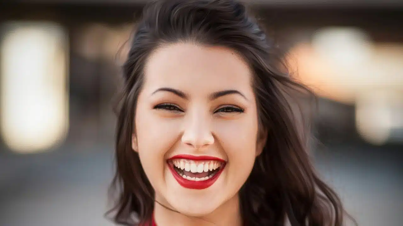 A woman smiling widely.