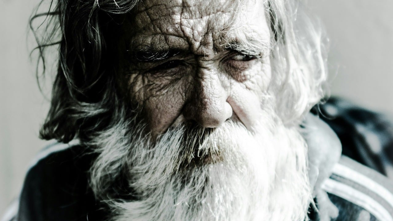 A bearded man with an unkempt appearance.
