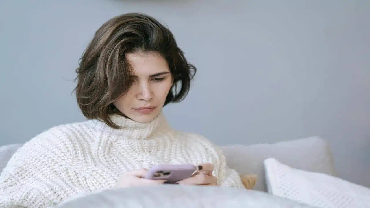 A woman looking sad while texting