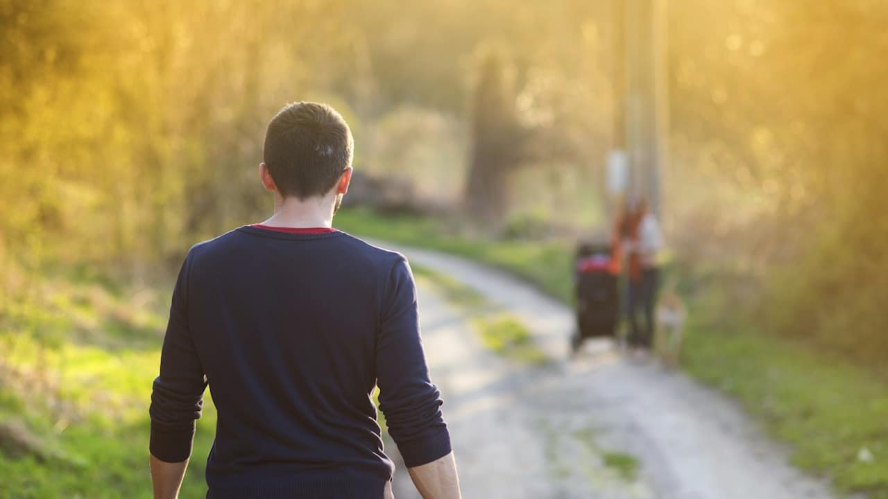 A man walking towards his partner.