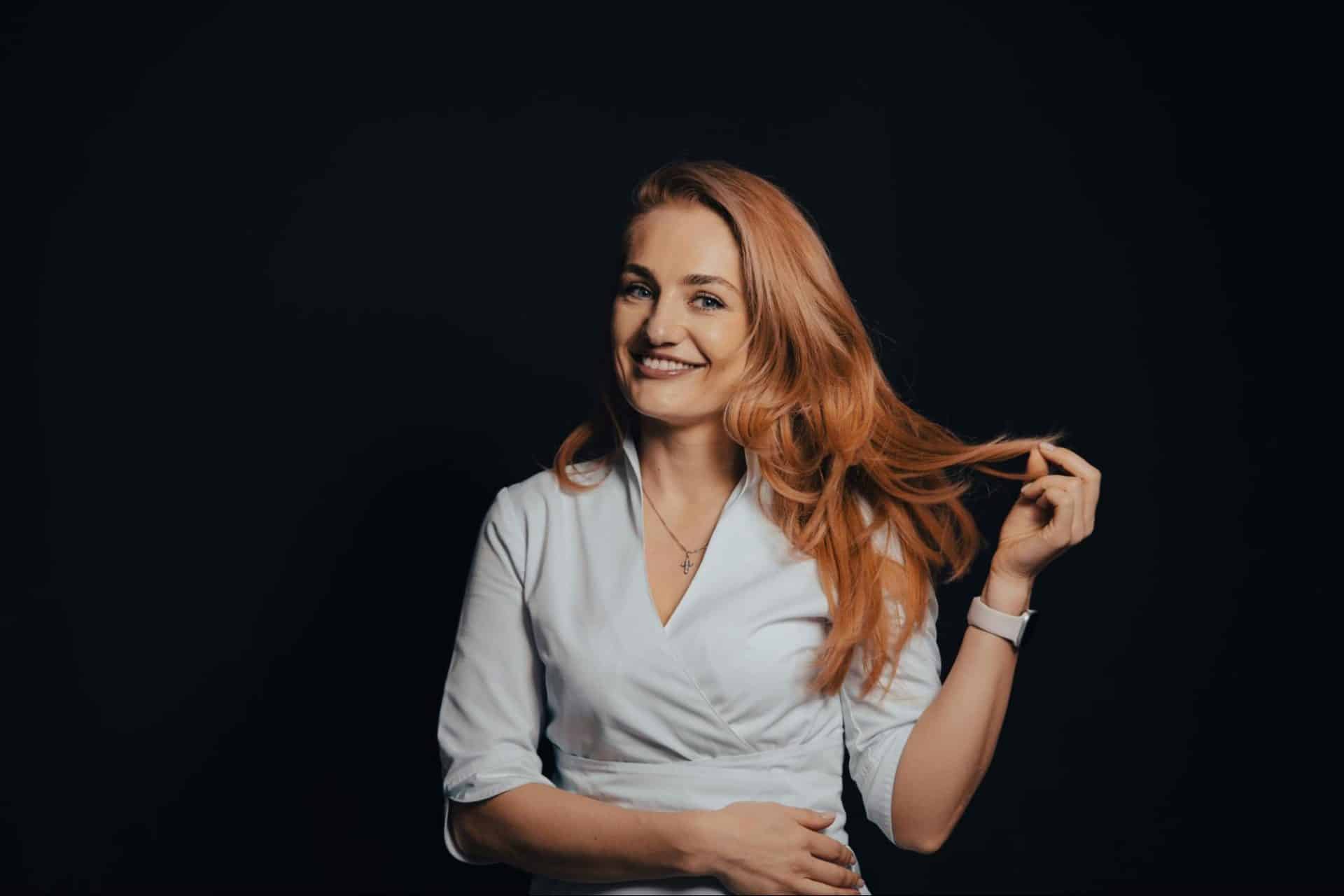 Woman smiling confidently with relaxed and composed posture