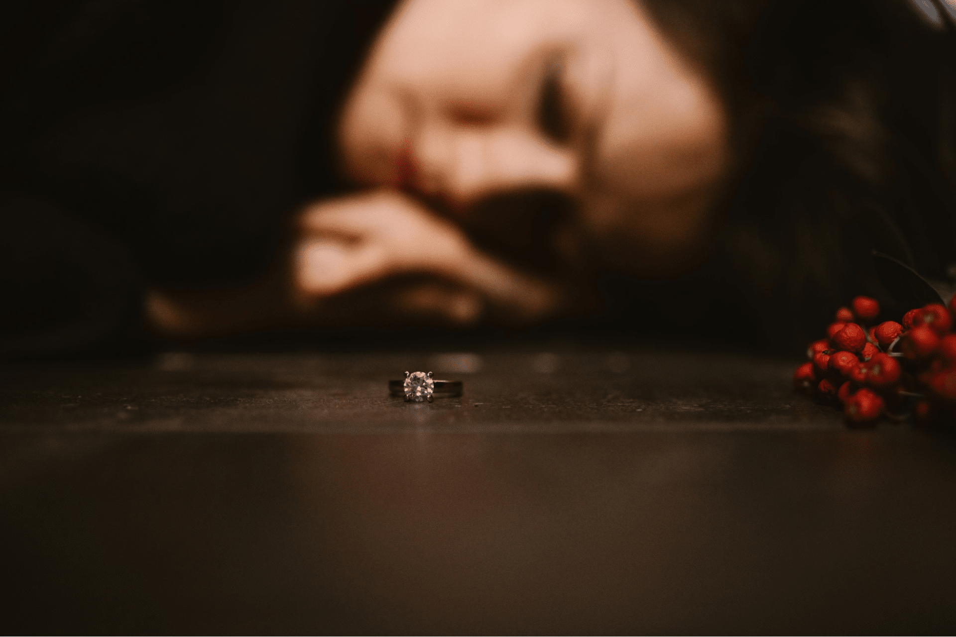 A woman feeling heartbroken and sad as she sees her ring.