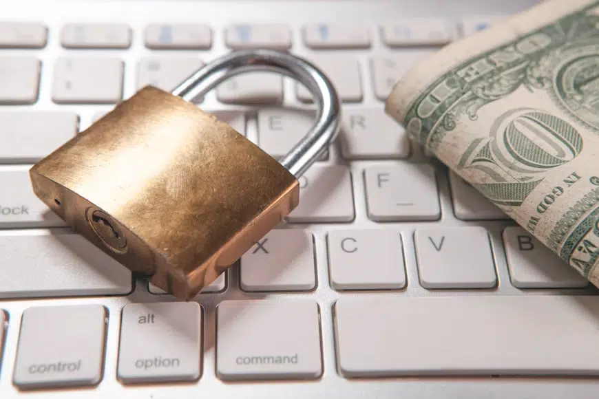 A lock with dollars on a keyboard.