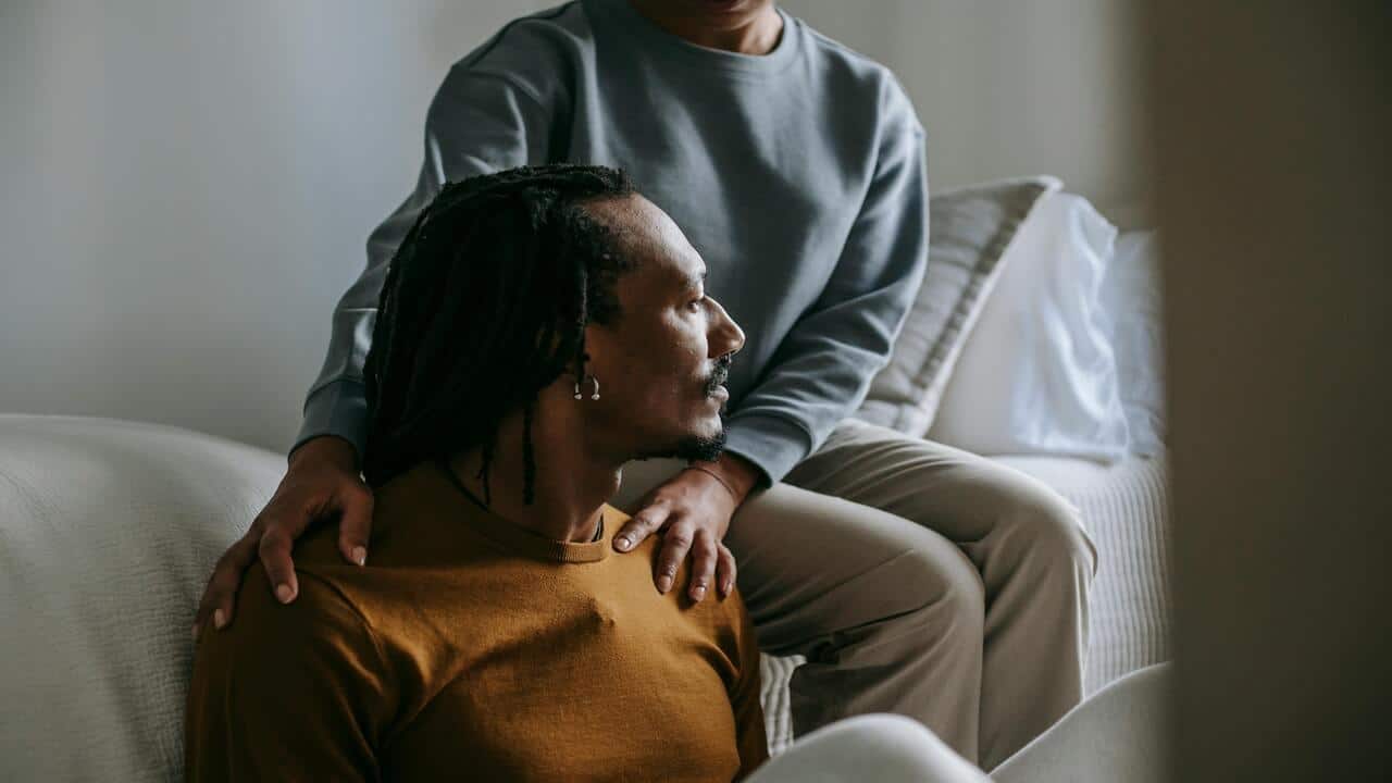 A woman listening to her upset husband.