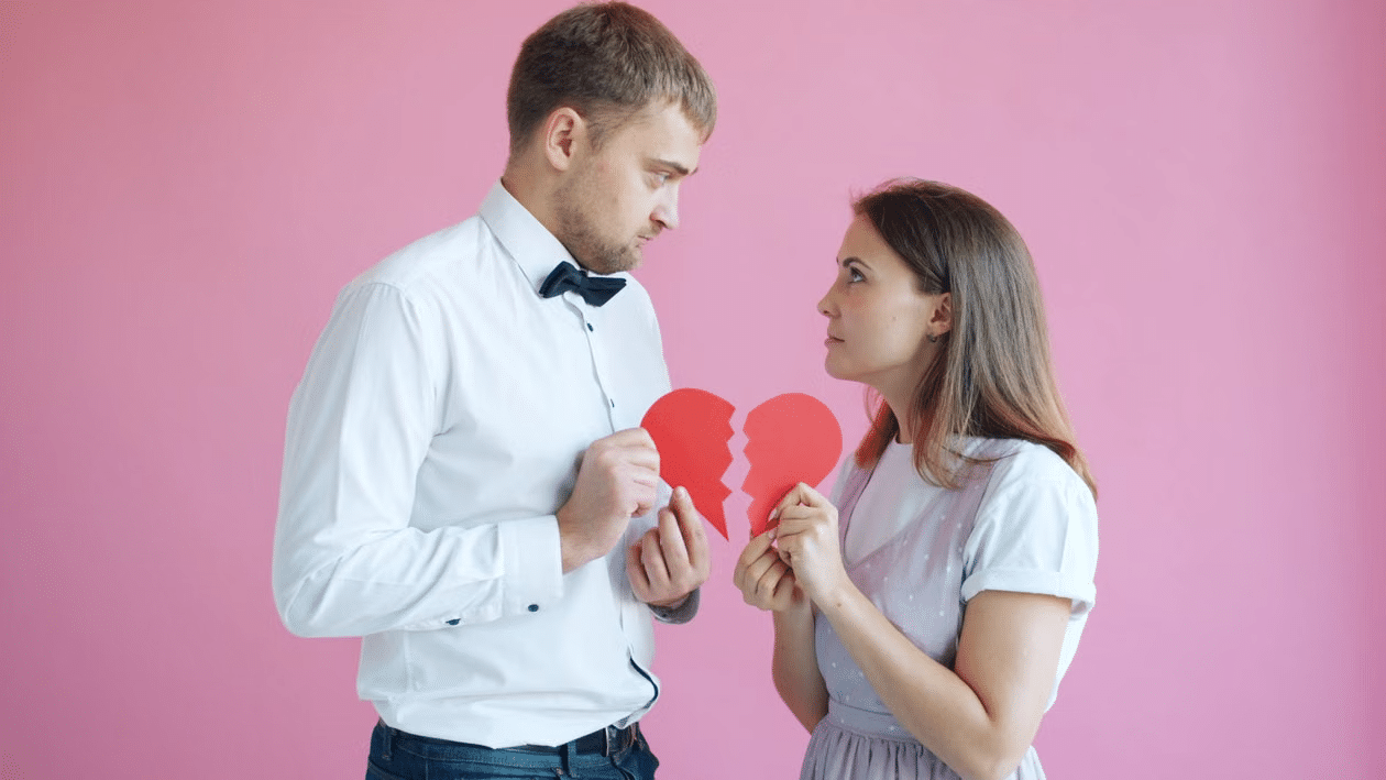 A couple looking at each other with an empty look as their hearts aren't connected.