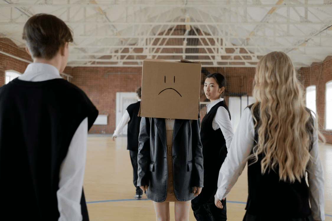 A woman with a box on head symbolizing her feeling of being out of place.