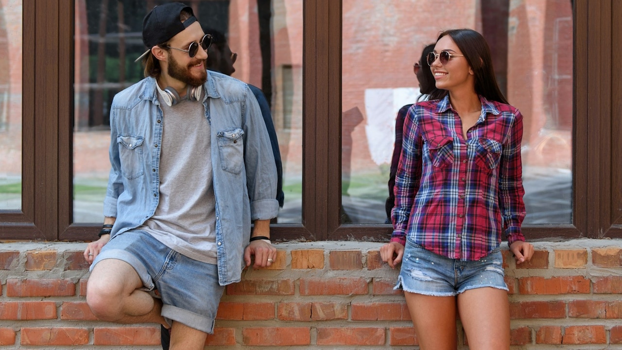 A young man and woman are talking and flirting.