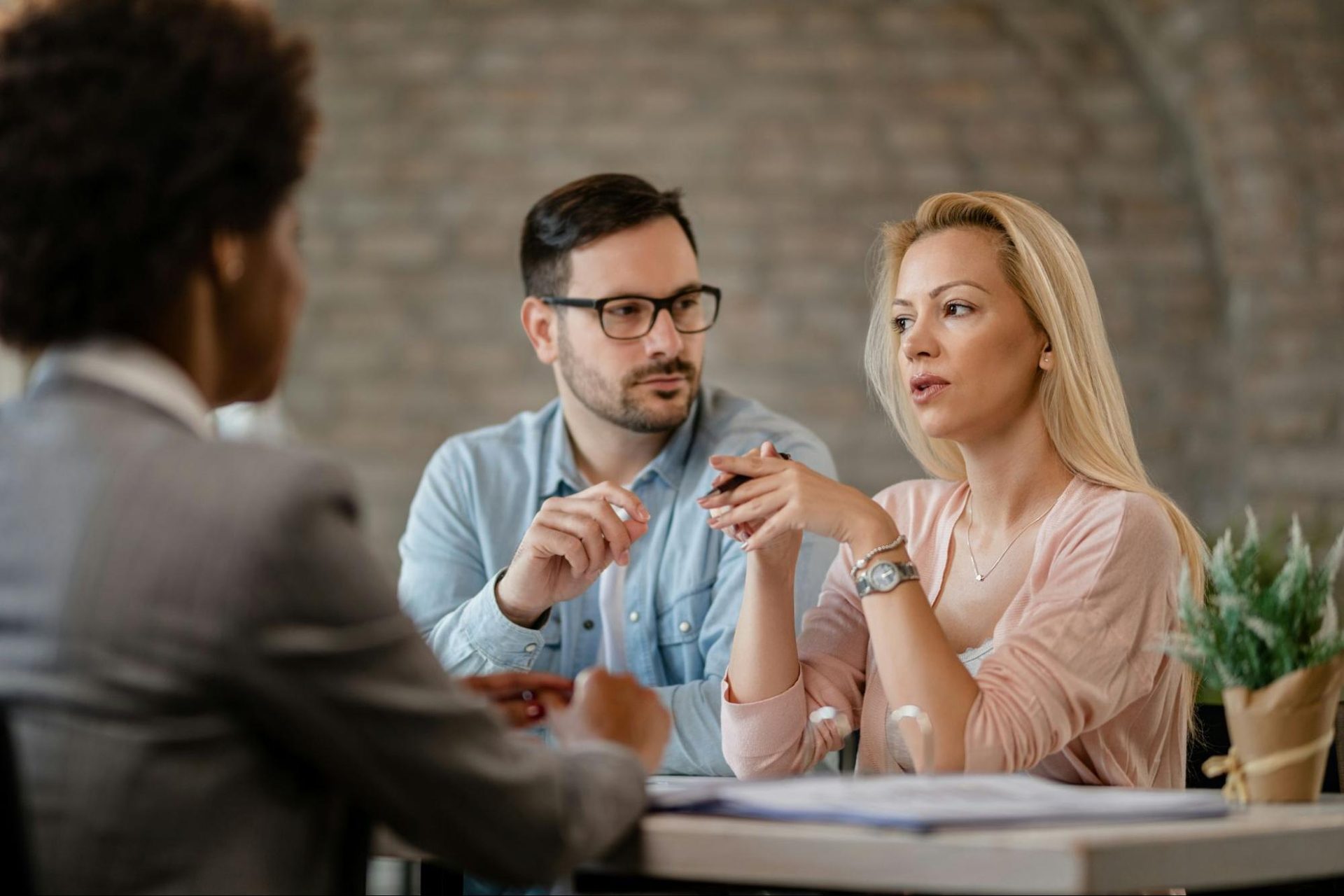 A woman speaking and a man listening to her.