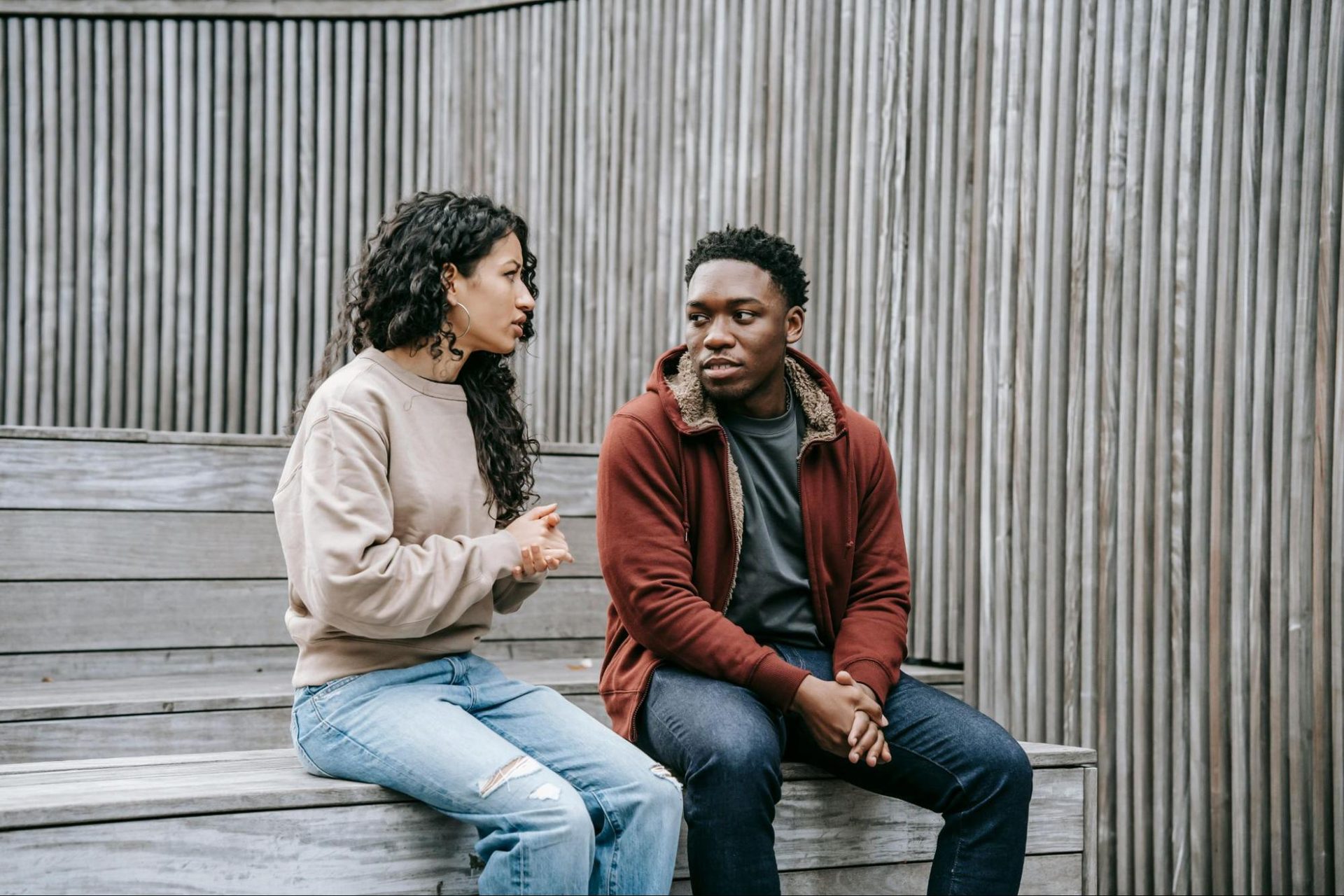 Couple sitting calmly and talking face to face during a disagreement