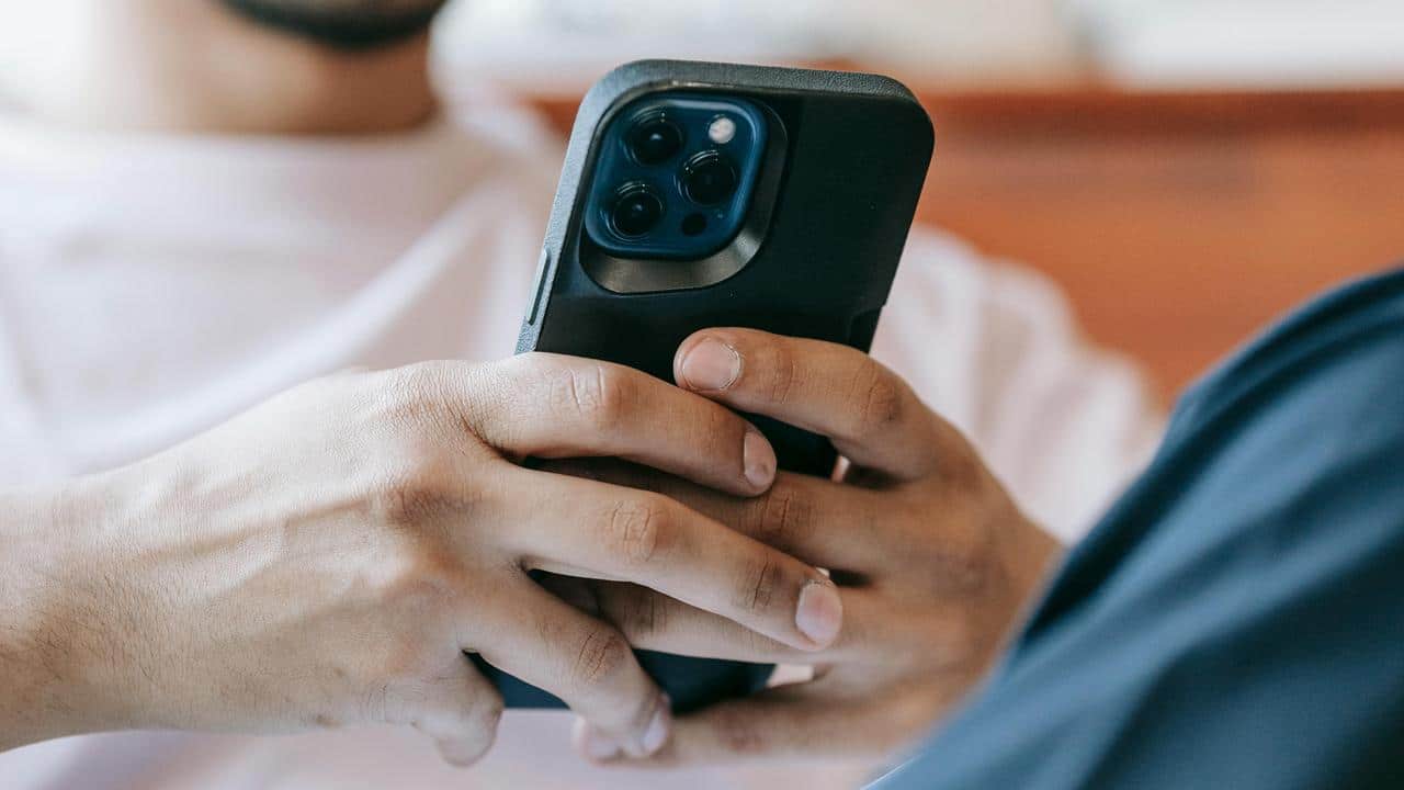 A close-up of someone holding a smartphone with both hands.