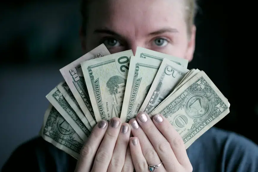 A woman holding money symbolizing how money holds power.