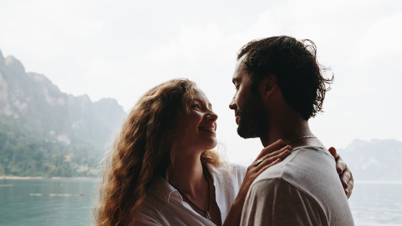 A beautiful couple having a romantic moment in a hilly area.