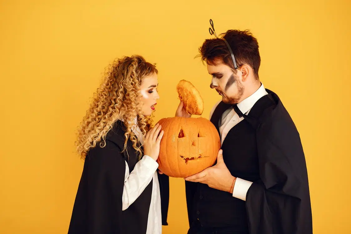 A Halloween couple dressed as a wizard and witch.