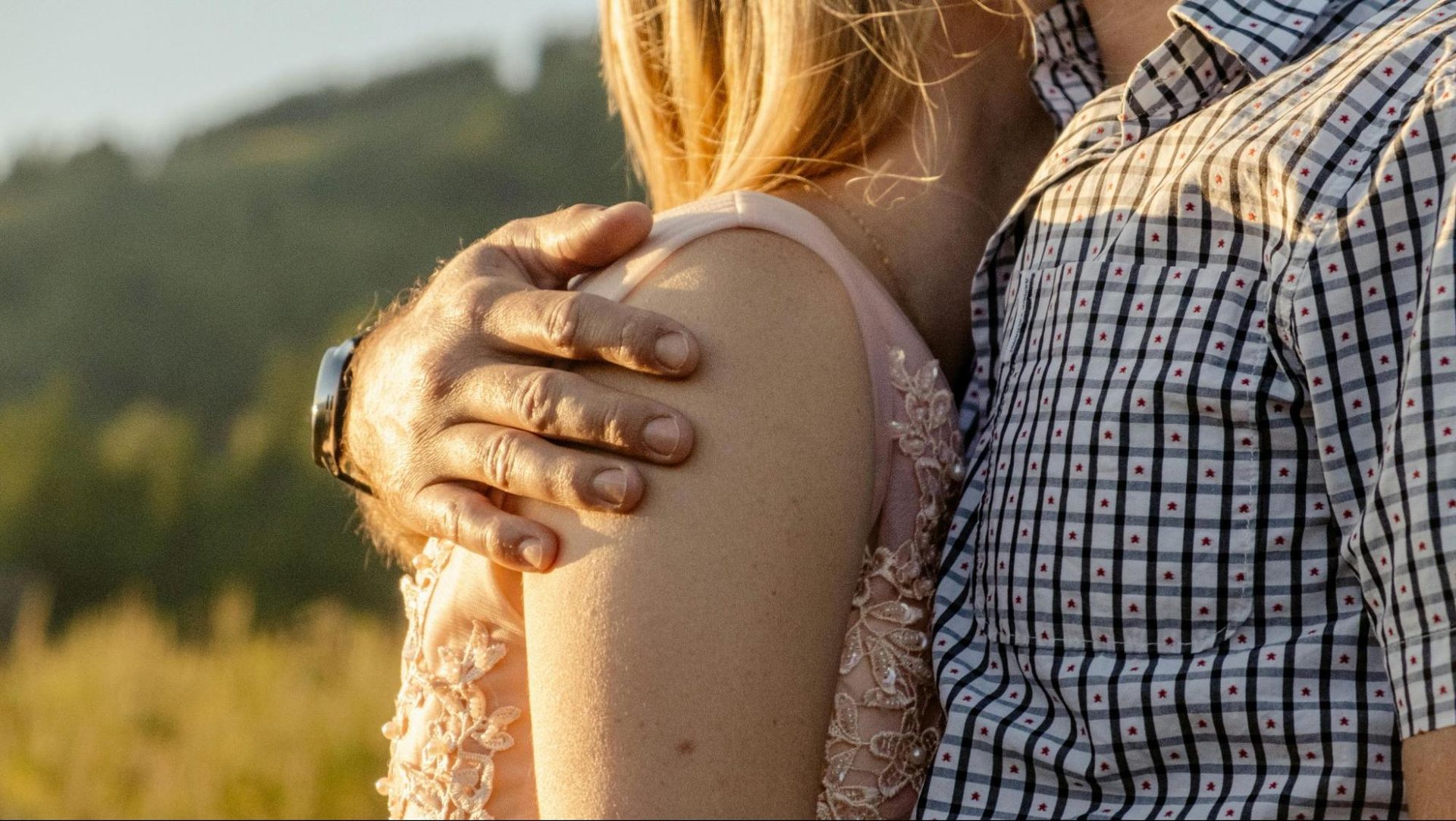 Man gently hugging a woman