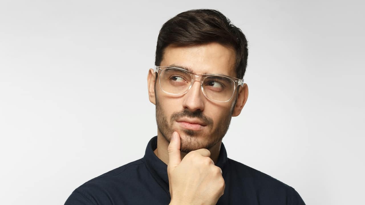 A man wearing glasses thinking deeply.