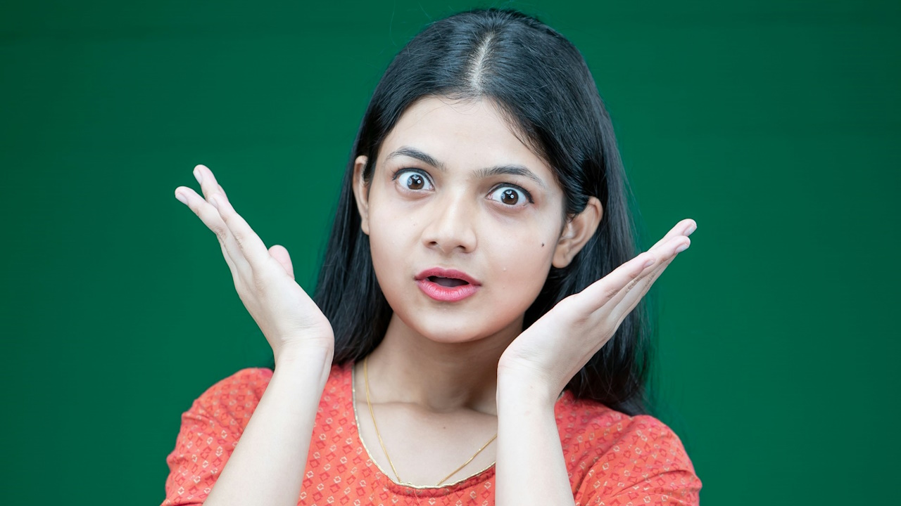 A woman making a hand gesture with her hands.