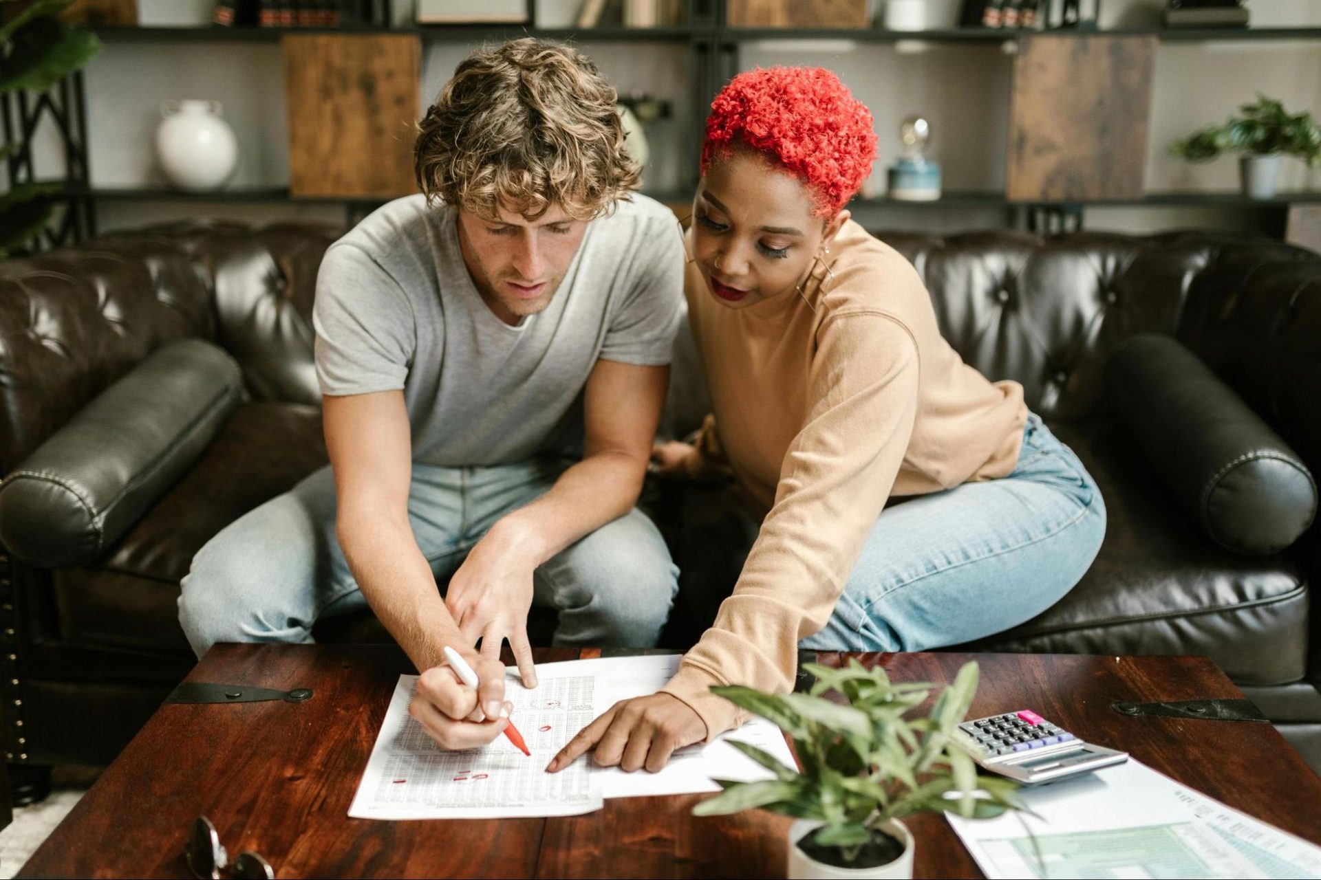 Woman working on a hobby while a man supports nearby