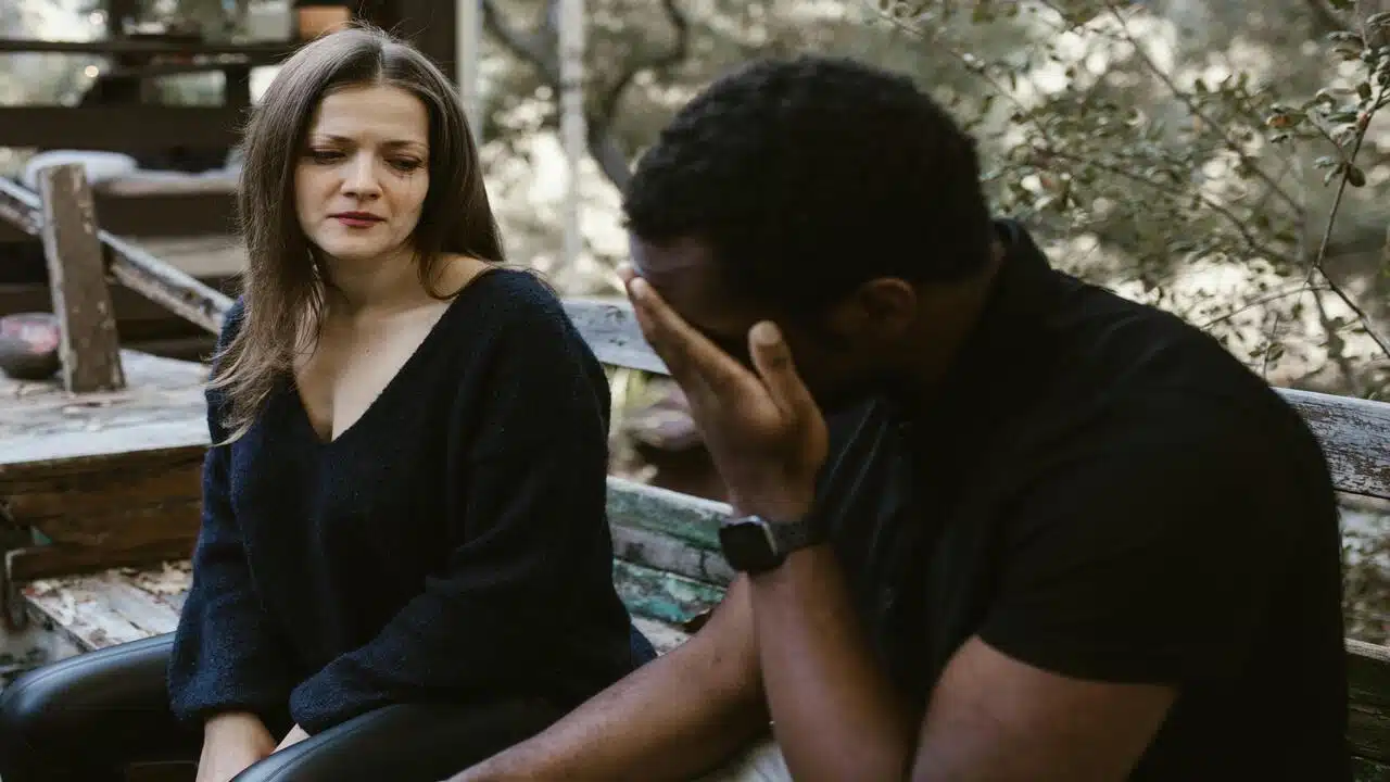 A couple crying on a bench