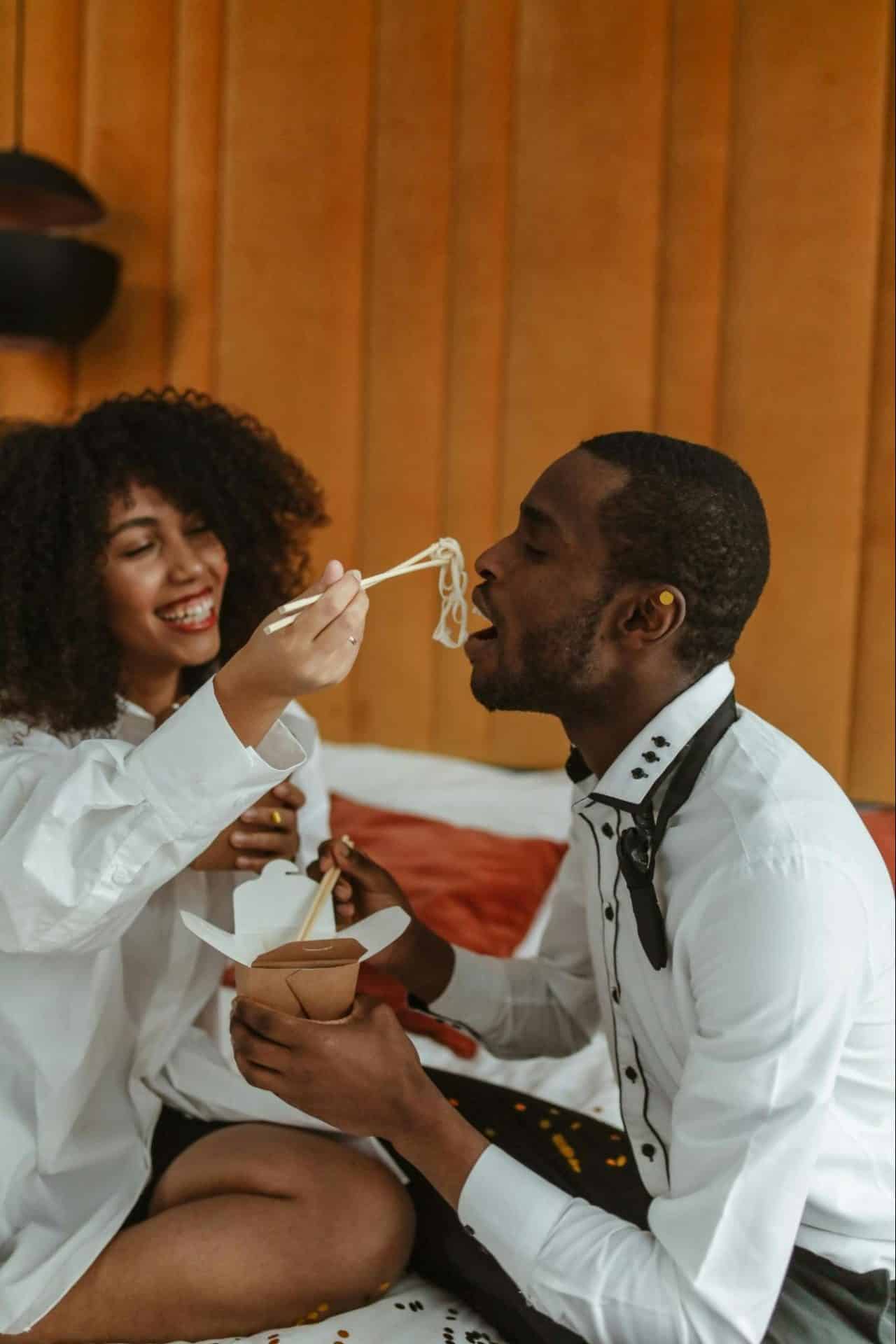 Couple laughing together while maintaining an elegant appearance