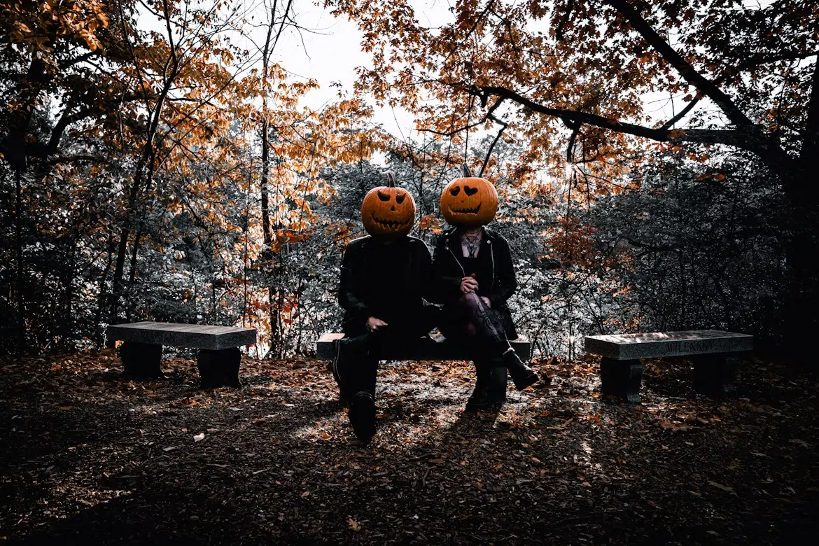 A couple sitting together on a bench.