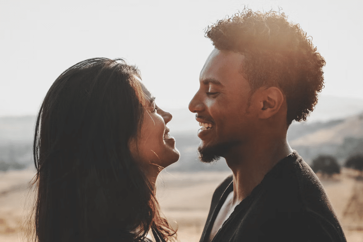 A man and woman smiling and looking at each other