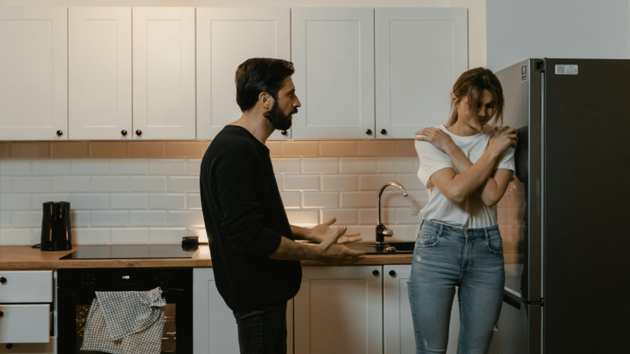 A couple having an argument in the kitchen.