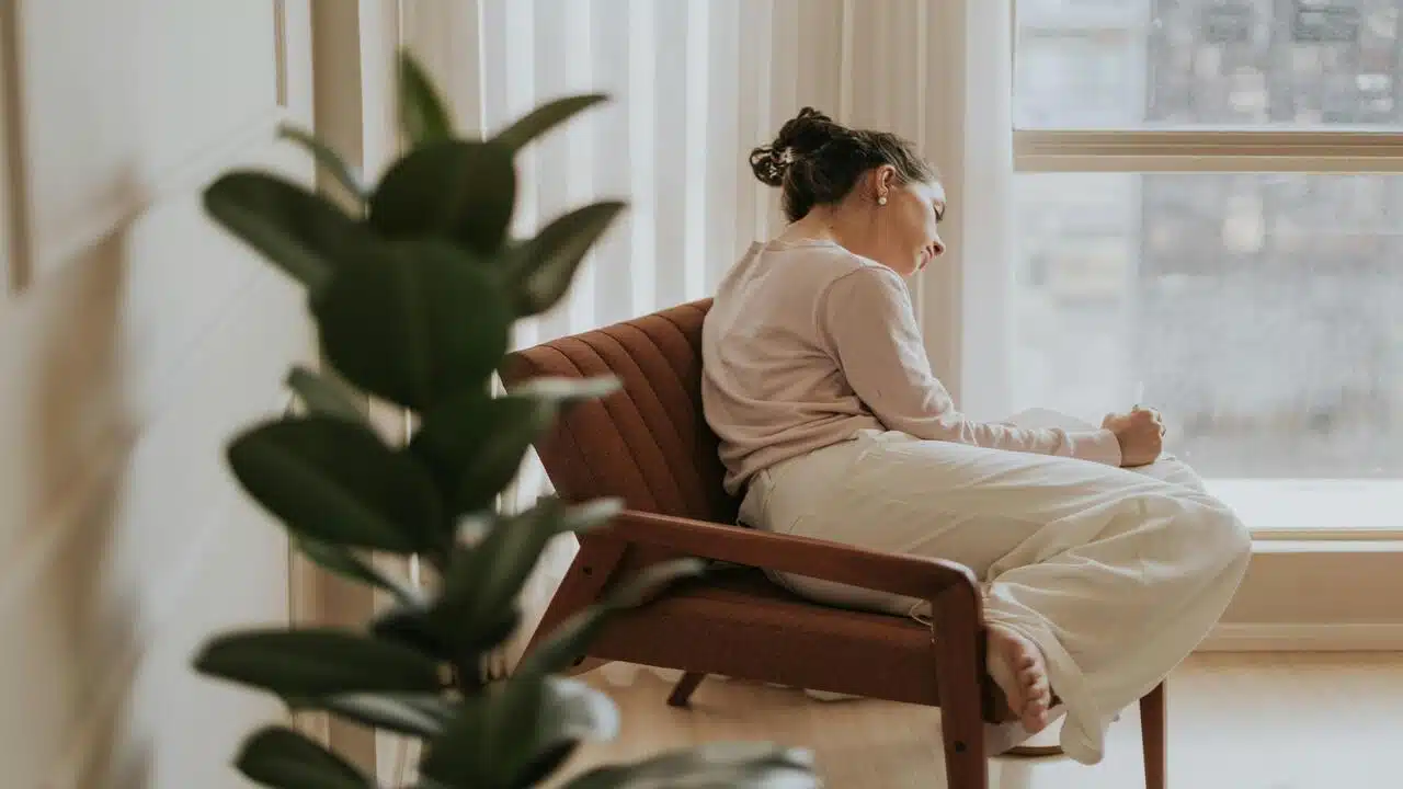 A woman looking sad at home