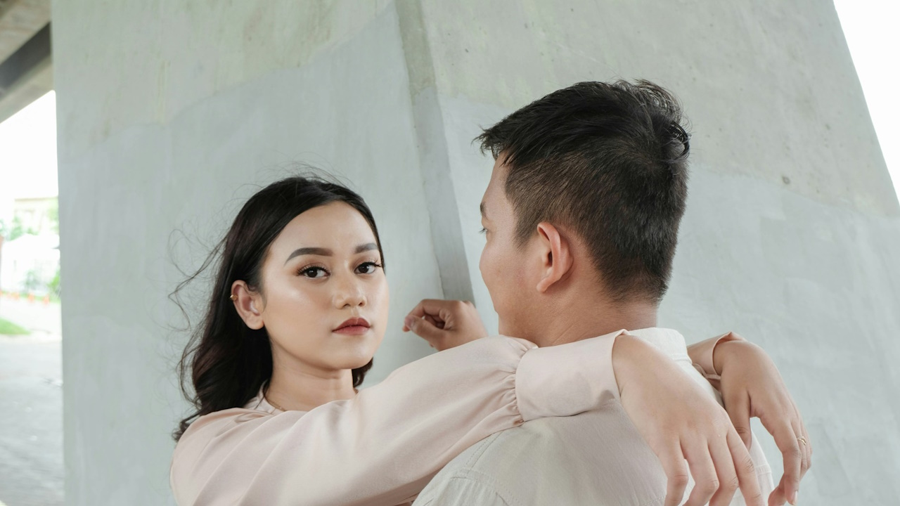 A man gazing at a woman who is looking at the camera.