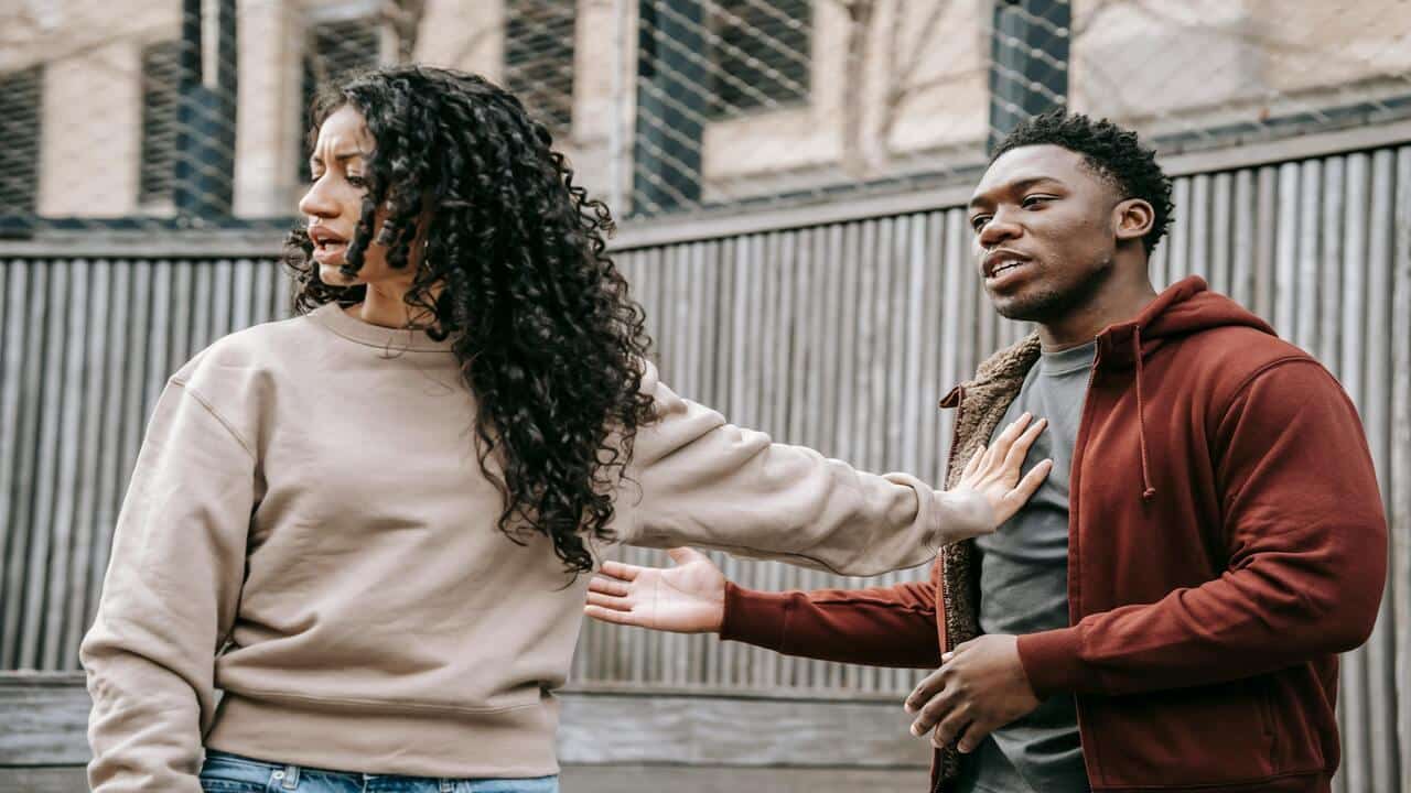 A couple arguing outdoors