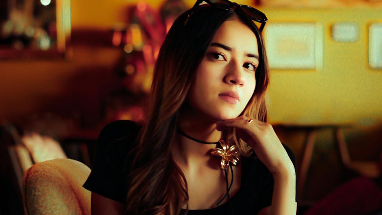 Chic woman relaxing in a retro cafe interior.
