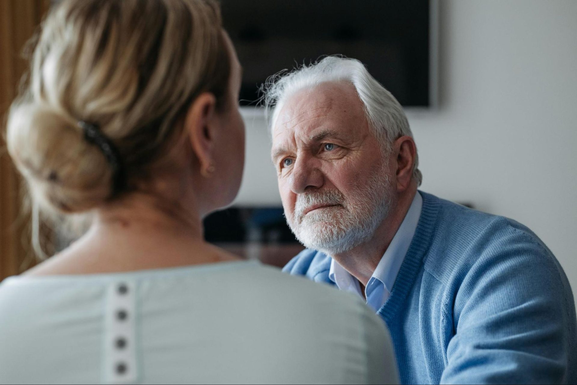 Woman speaking seriously while a man listens closely without interruption