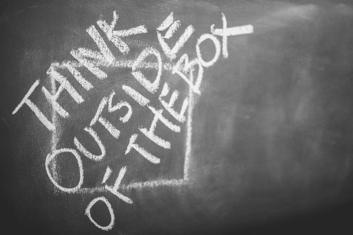 Think out of the box written with chalk.