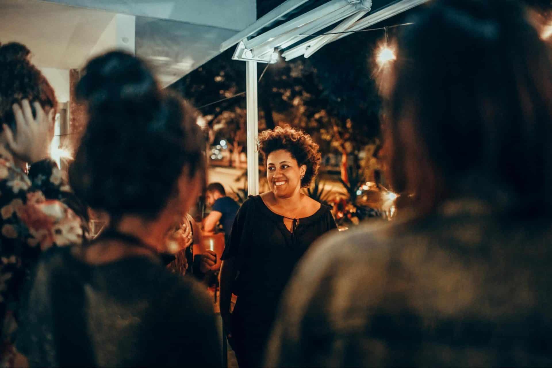 Woman treating others kindly in a social setting with grace