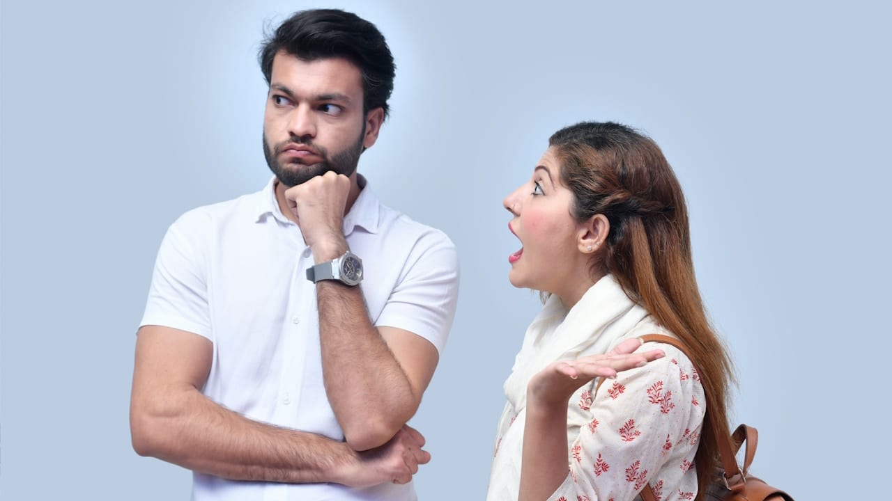A man ignoring his complaining wife.