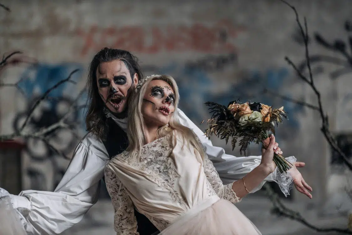 A couple in Halloween costumes.