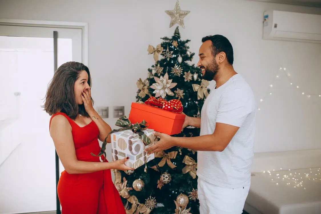 A man giving a present to a woman.