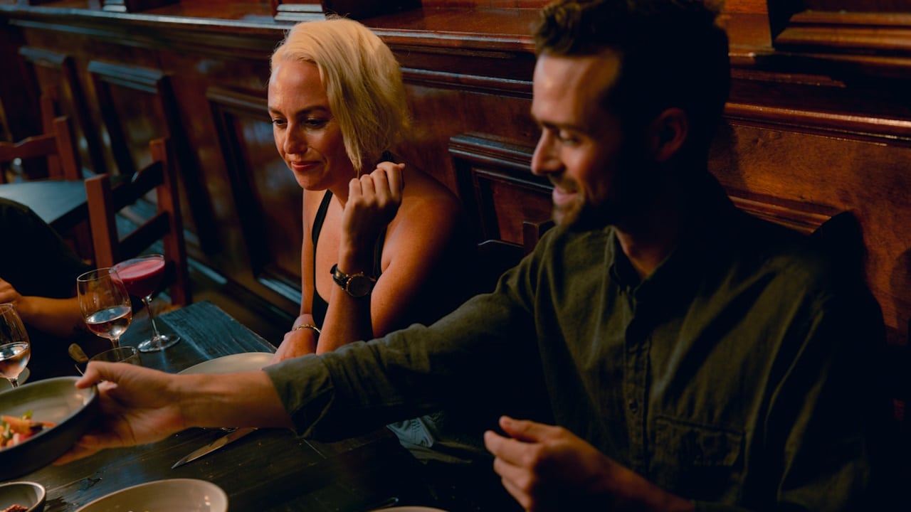 A couple sitting on a plate of food.