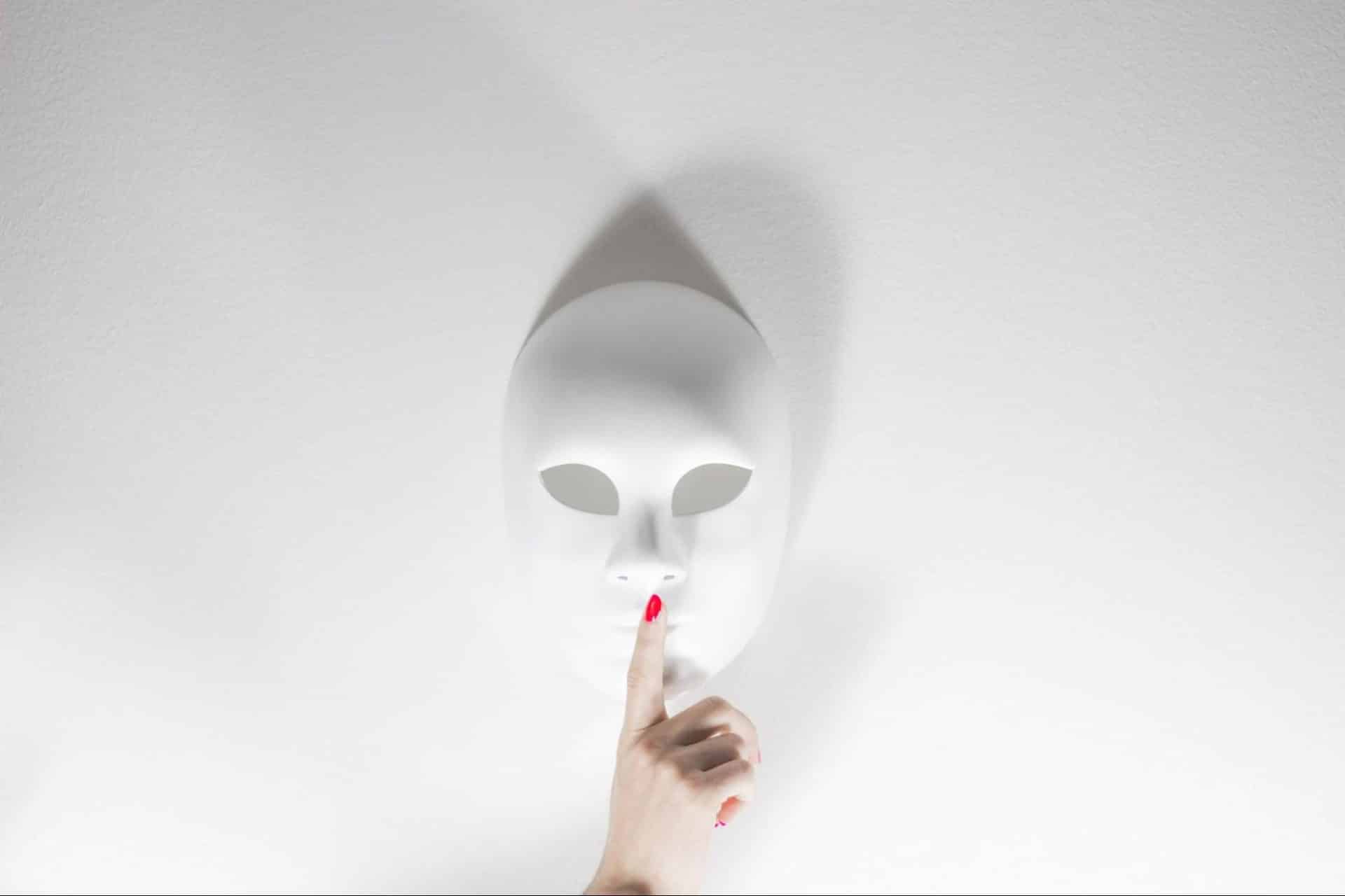 Be silent gesture hinting at keeping information hidden.