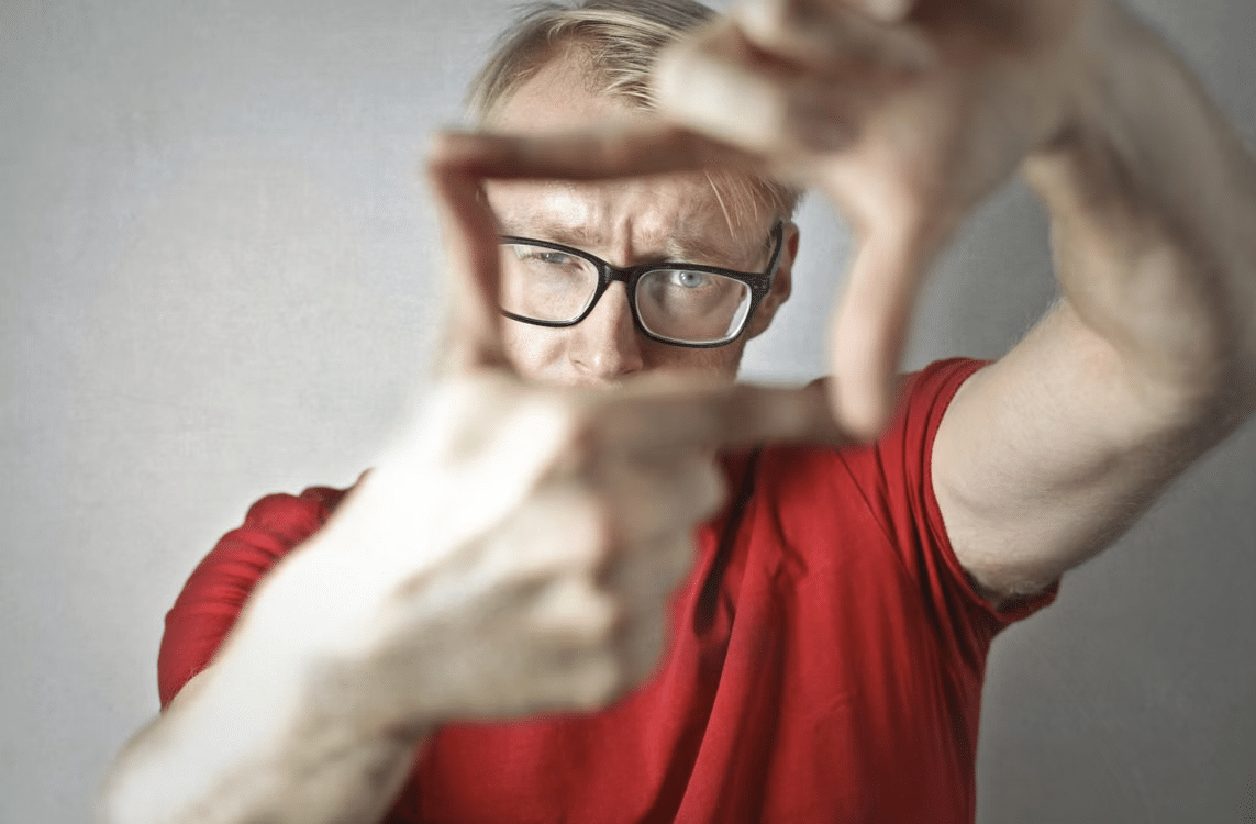 A young man making frame with fingers.