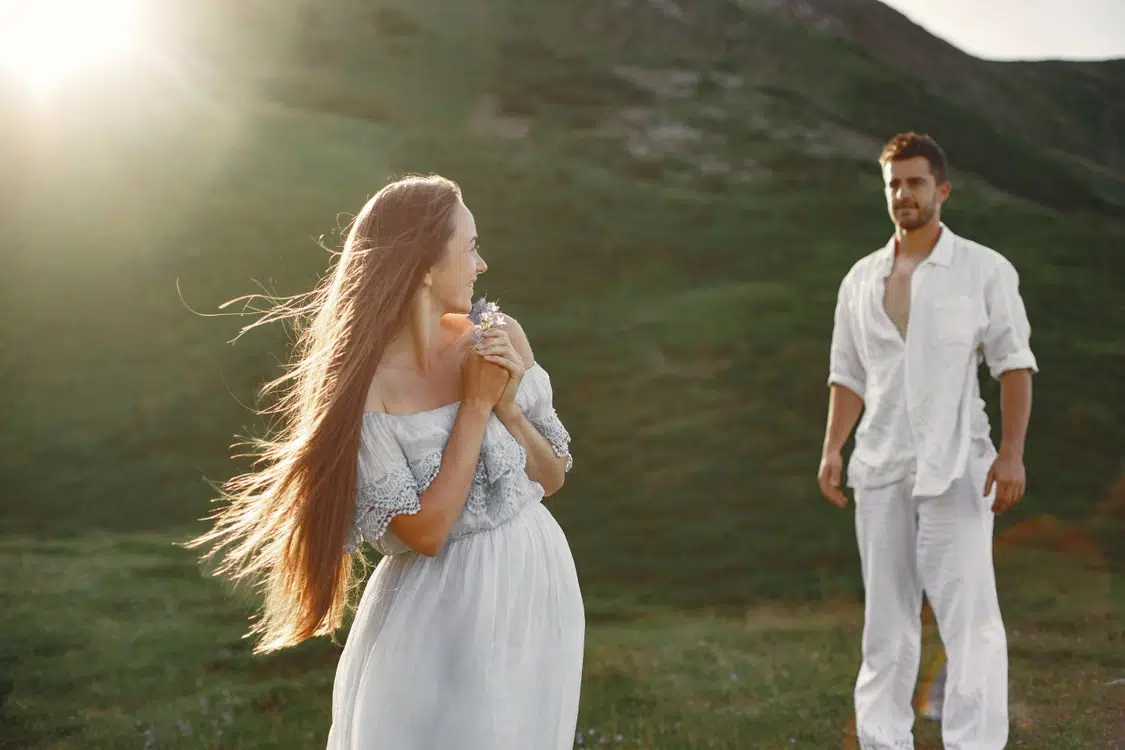 A man adoring a woman from a distance.