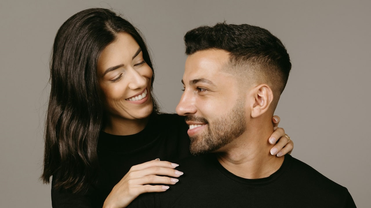 A woman smiling at a man.