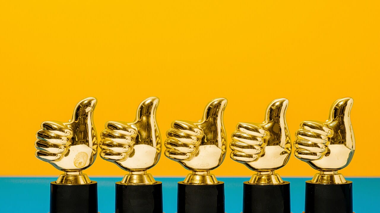 A photo of thumbs up trophies