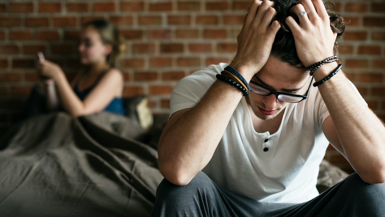 A woman is busy on her phone, leaving her partner alone.