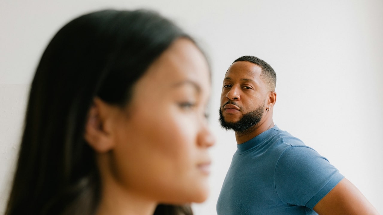 A man looking at a woman with anger.